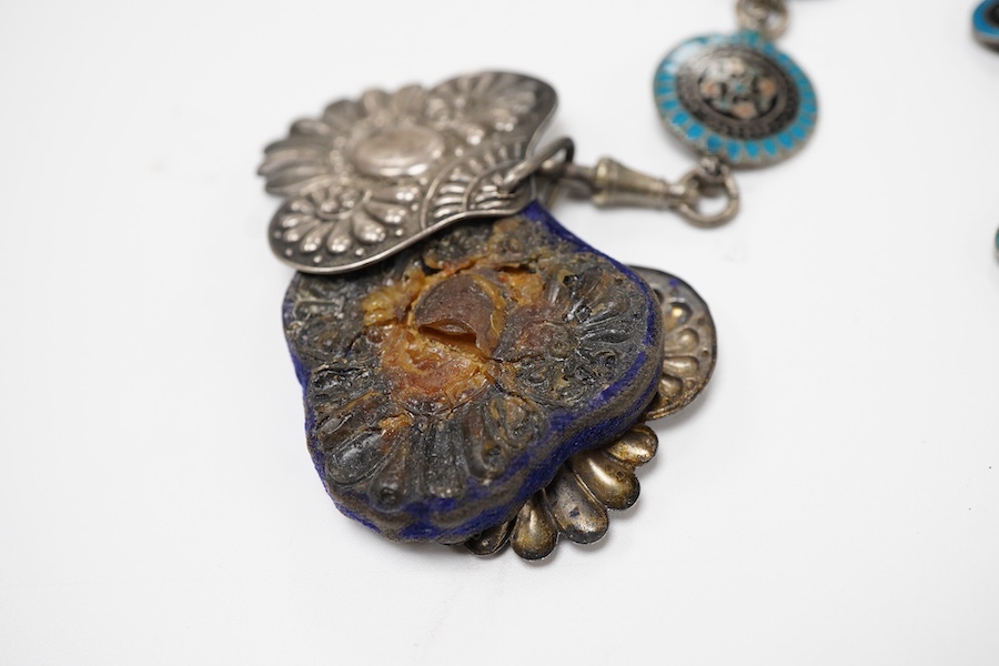 An enamel chatelaine, late 19th/early 20th century, composed of metal plaques applied with foliate patterns in blue, black and red enamel, indistinctly stamped maker's marks, suspending a silver pin cushion and a silver